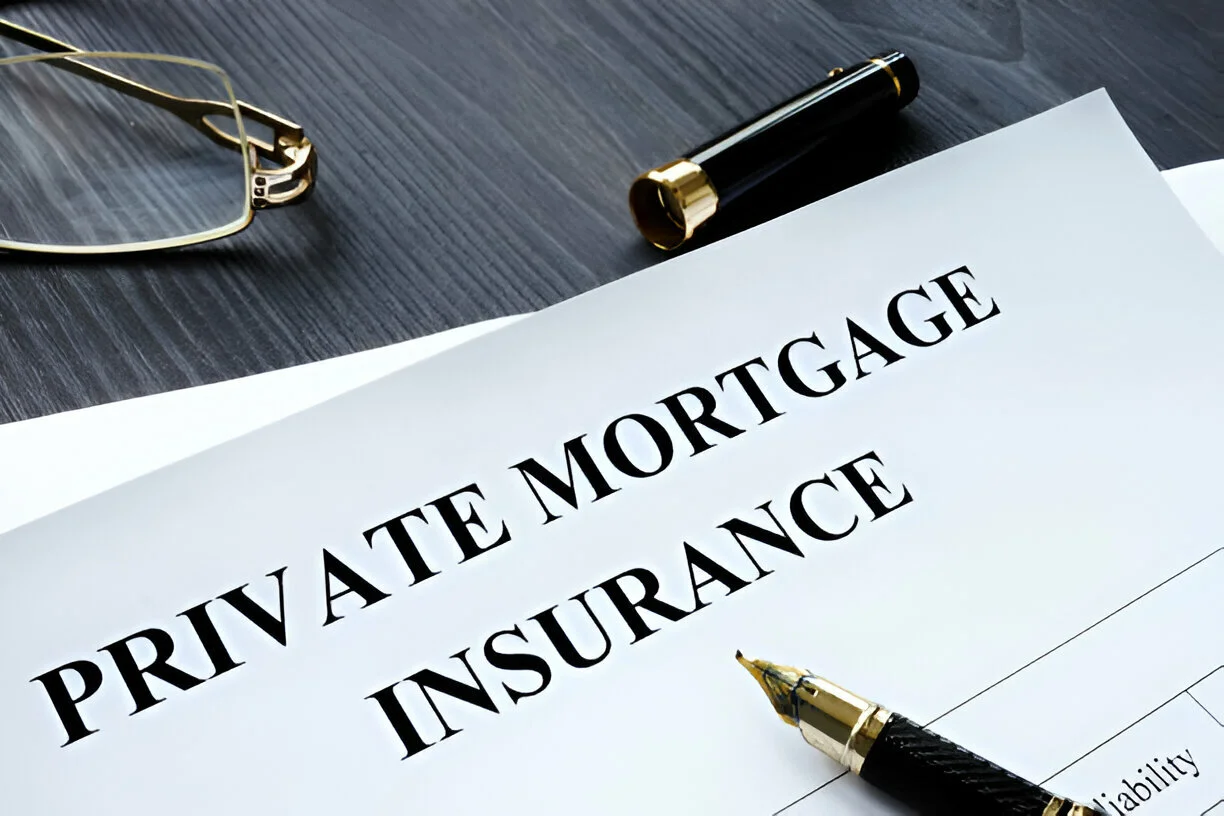 Private mortgage insurance document with pen and glasses on desk.